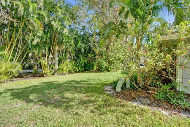 a kitchen with granite countertop a stove top oven sink and cabinets