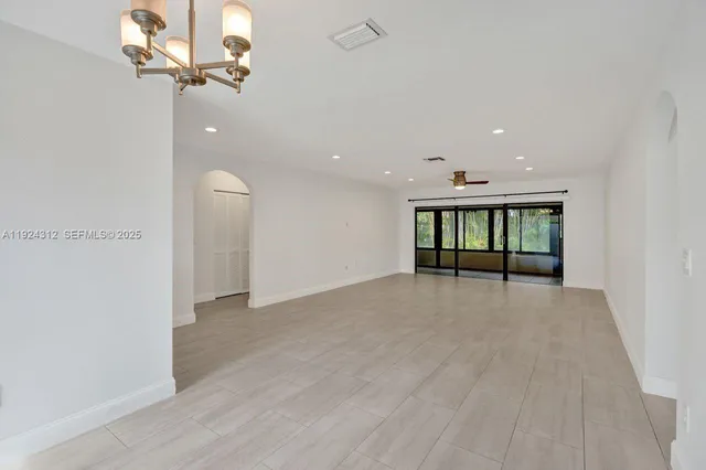 a kitchen with granite countertop a sink wooden cabinets and stainless steel appliances
