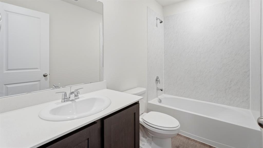 321 Tall Cedar Way Princeton, TX 75407 - Photo 7 of 8 a bathroom with a sink toilet vanity and shower