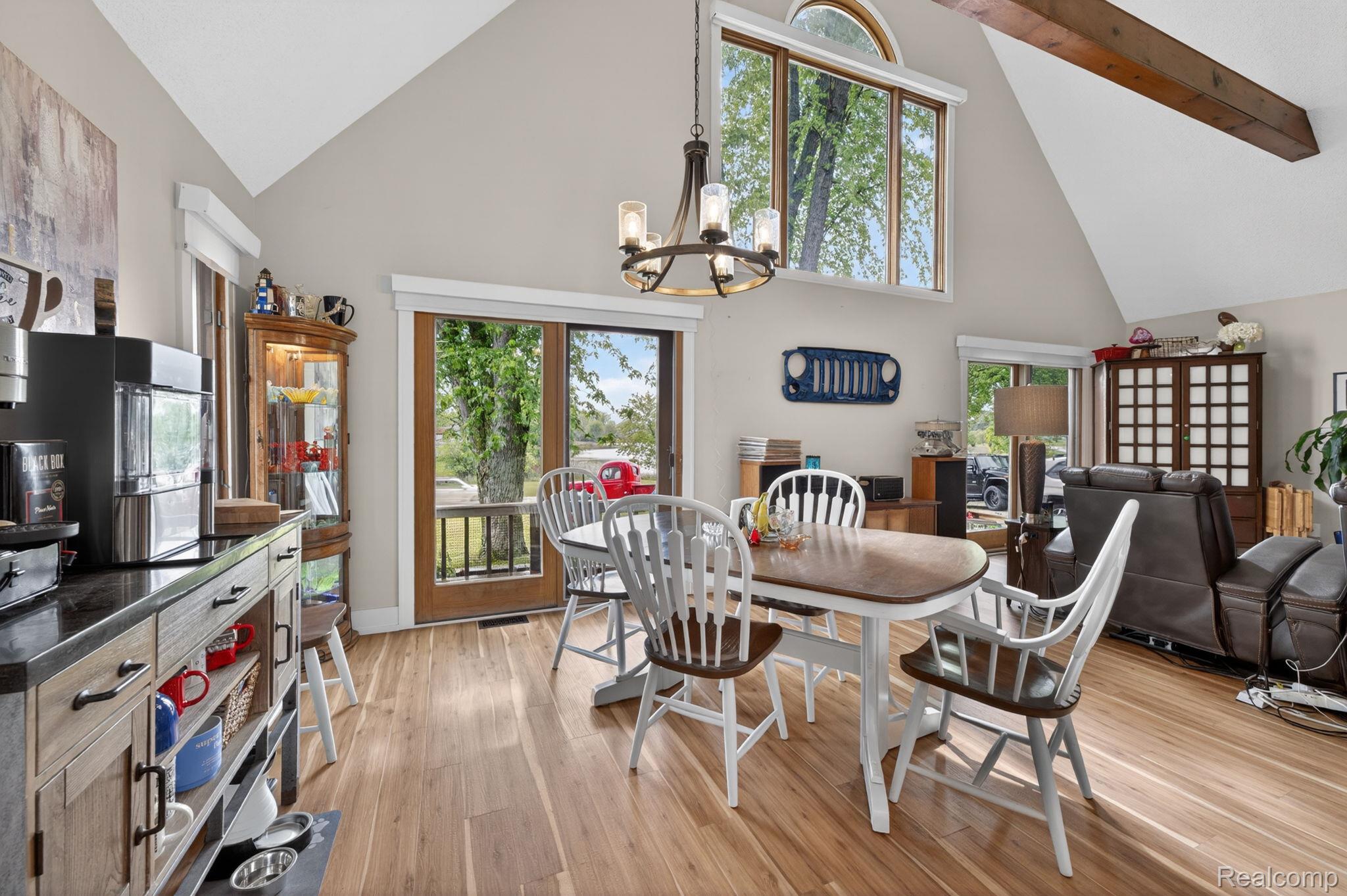 1280 Petts Road Fenton, MI 48430 - Photo 12 of 62 Dining space with vaulted ceiling, light wood finished floors, and suspended lighting