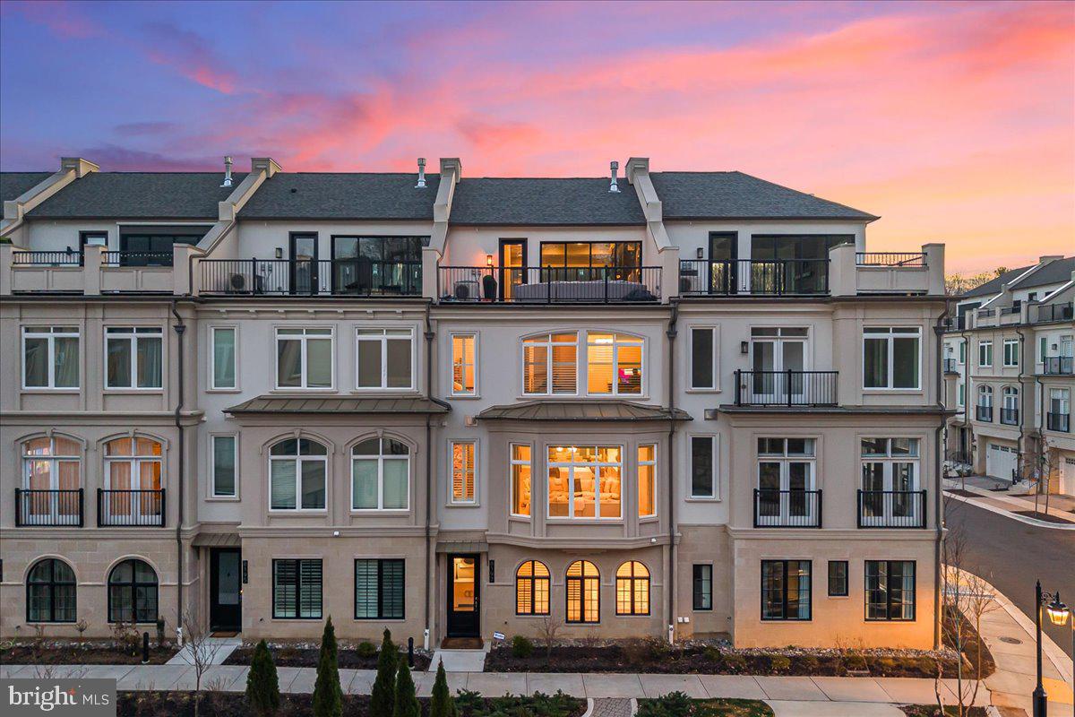 a front view of a building with glass windows and brick walls