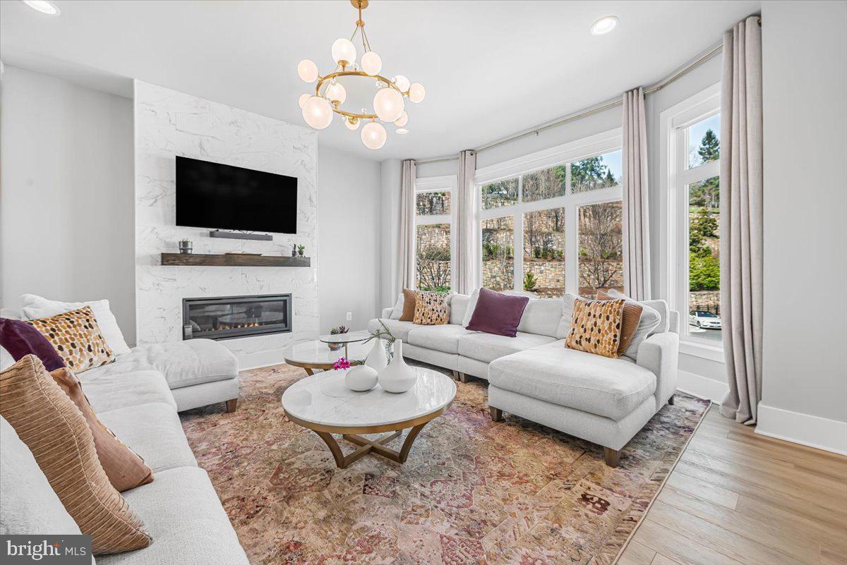 8197 River Road Bethesda, MD 20817 - Photo 18 of 53 a living room with furniture fireplace and a flat screen tv