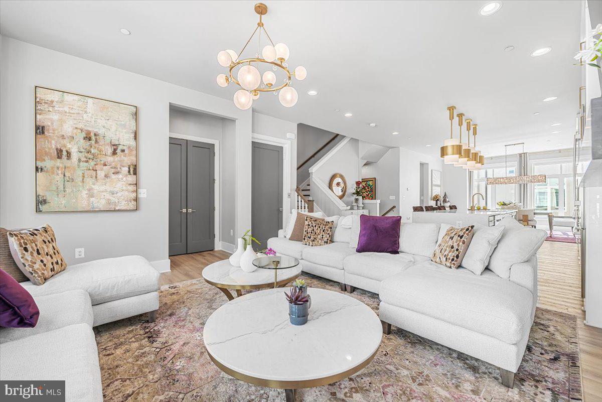 8197 River Road Bethesda, MD 20817 - Photo 19 of 53 a living room with furniture kitchen and a chandelier