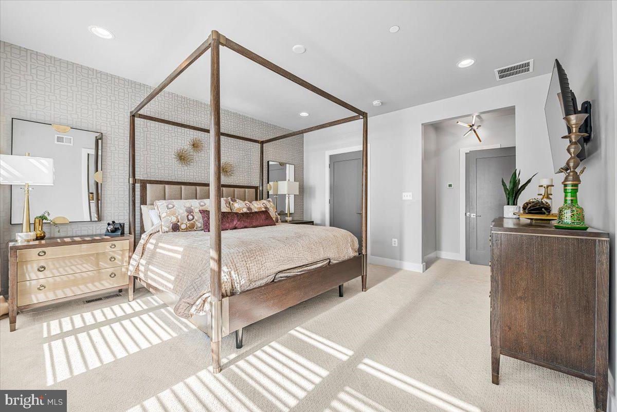 8197 River Road Bethesda, MD 20817 - Photo 23 of 53 a bedroom with a large bed and a chandelier