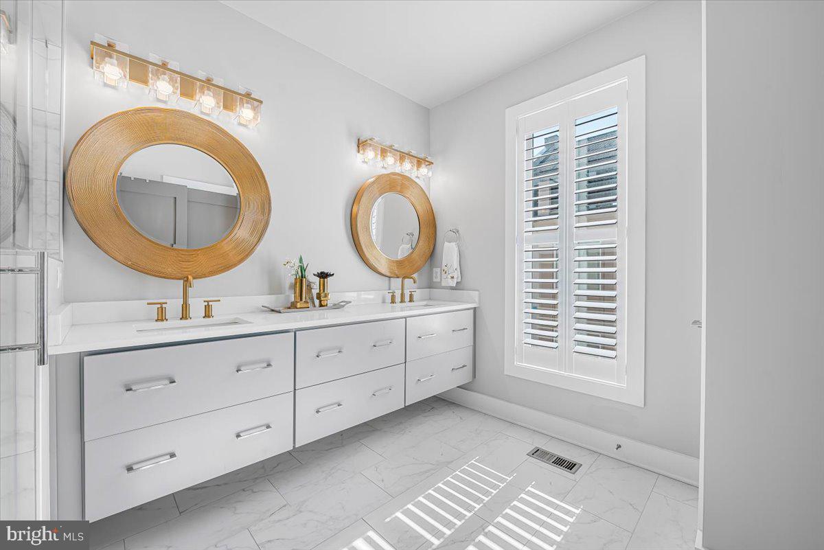 8197 River Road Bethesda, MD 20817 - Photo 24 of 53 a bathroom with a granite countertop double vanity sink and a mirror