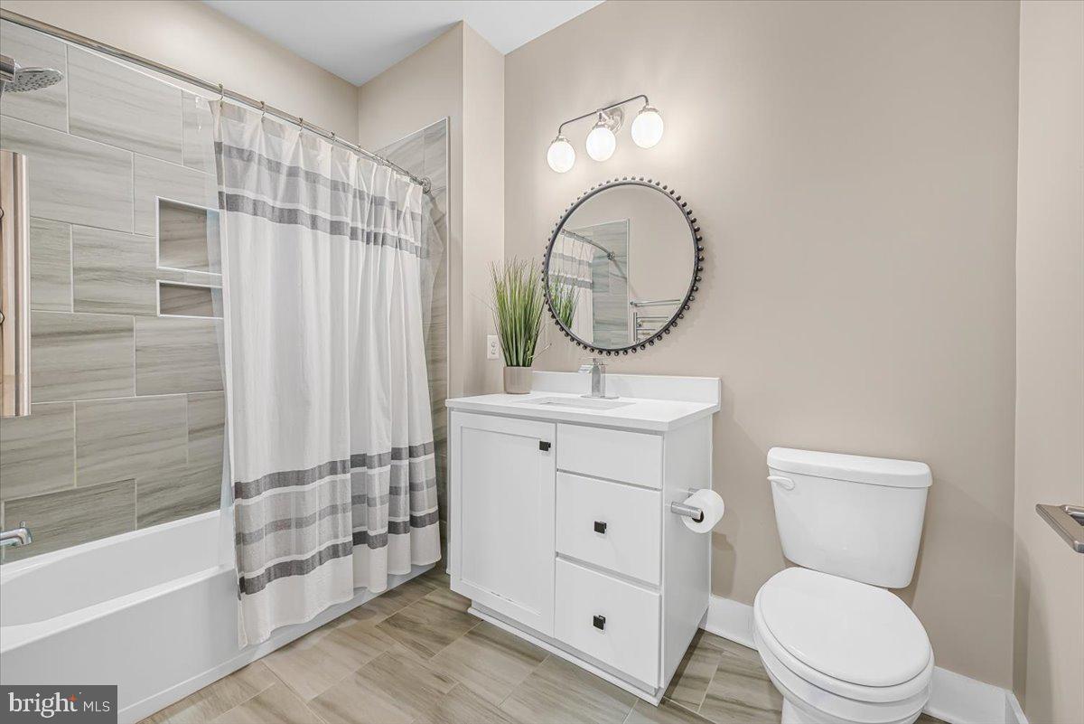8197 River Road Bethesda, MD 20817 - Photo 28 of 53 a bathroom with a toilet a sink and mirror