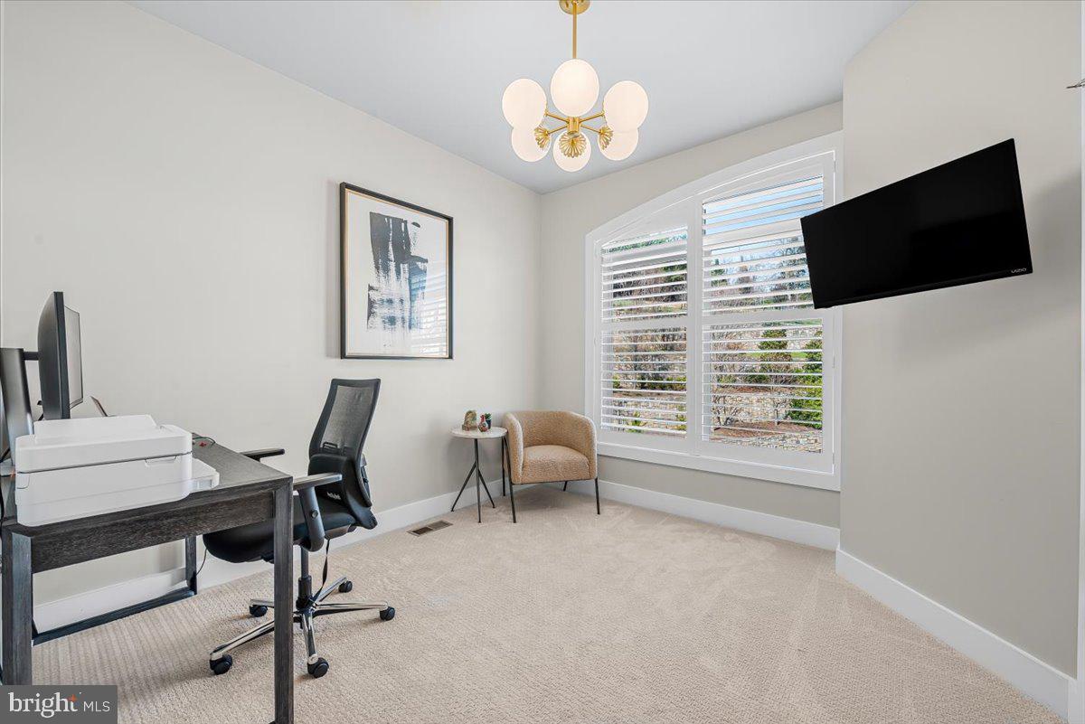 8197 River Road Bethesda, MD 20817 - Photo 29 of 53 a view of a workspace with furniture and a window