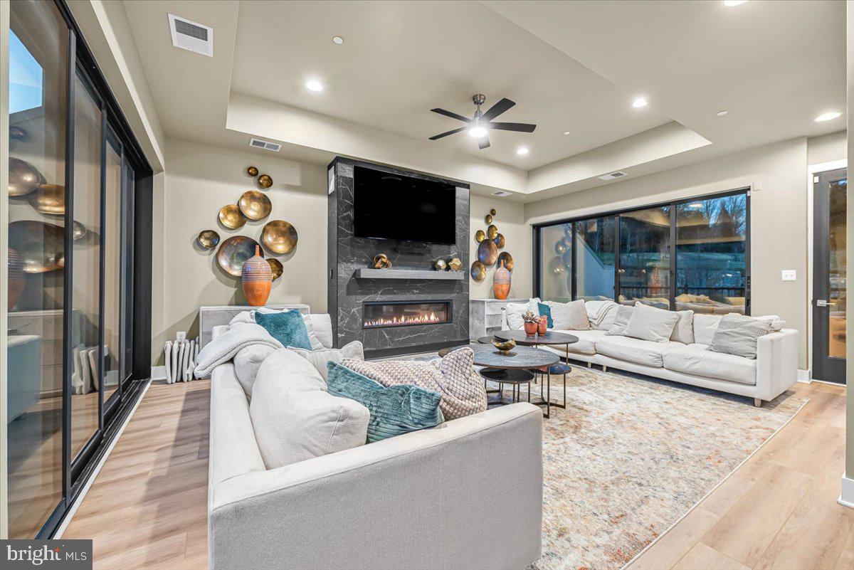 8197 River Road Bethesda, MD 20817 - Photo 32 of 53 a living room with fireplace furniture and a flat screen tv