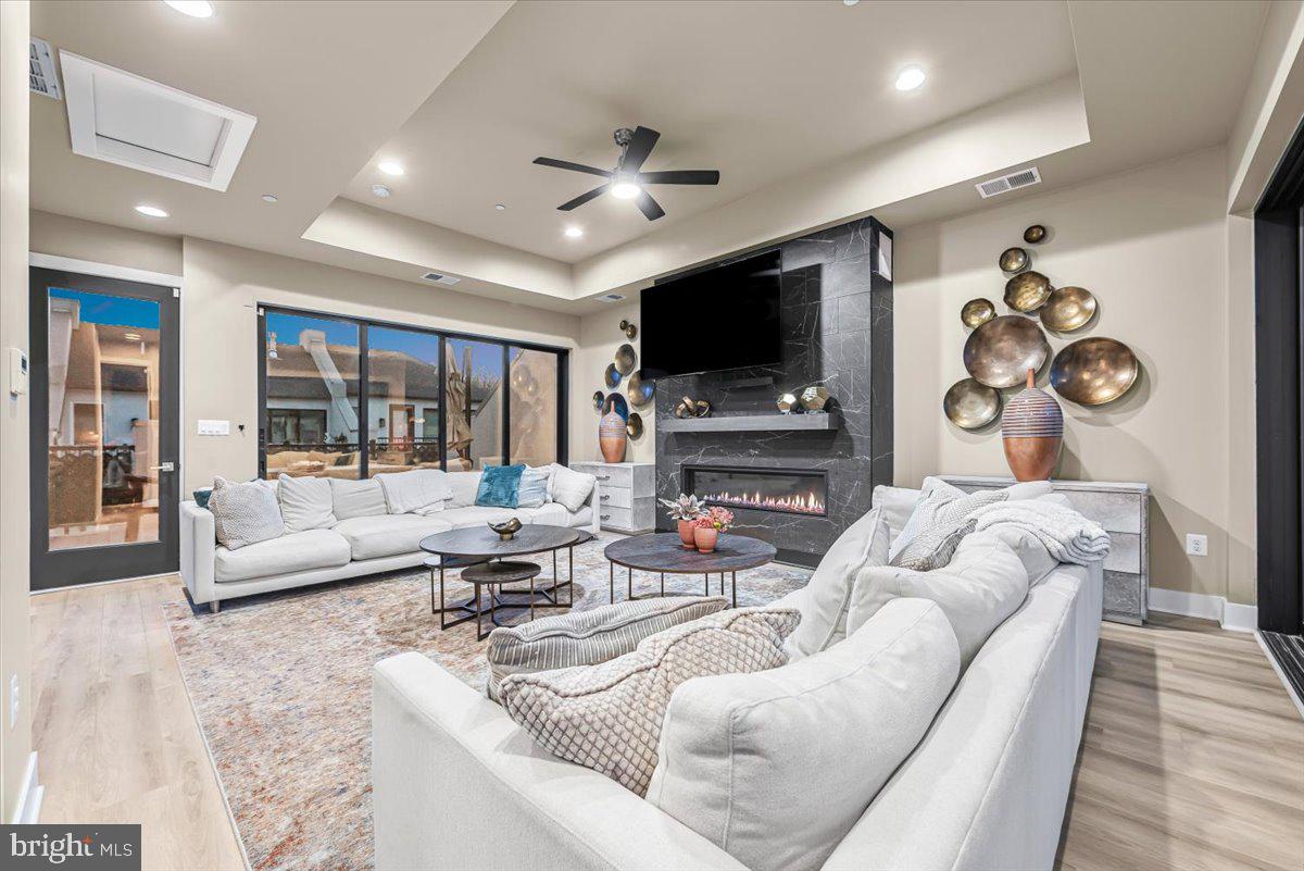 8197 River Road Bethesda, MD 20817 - Photo 33 of 53 a living room with fireplace furniture and a flat screen tv