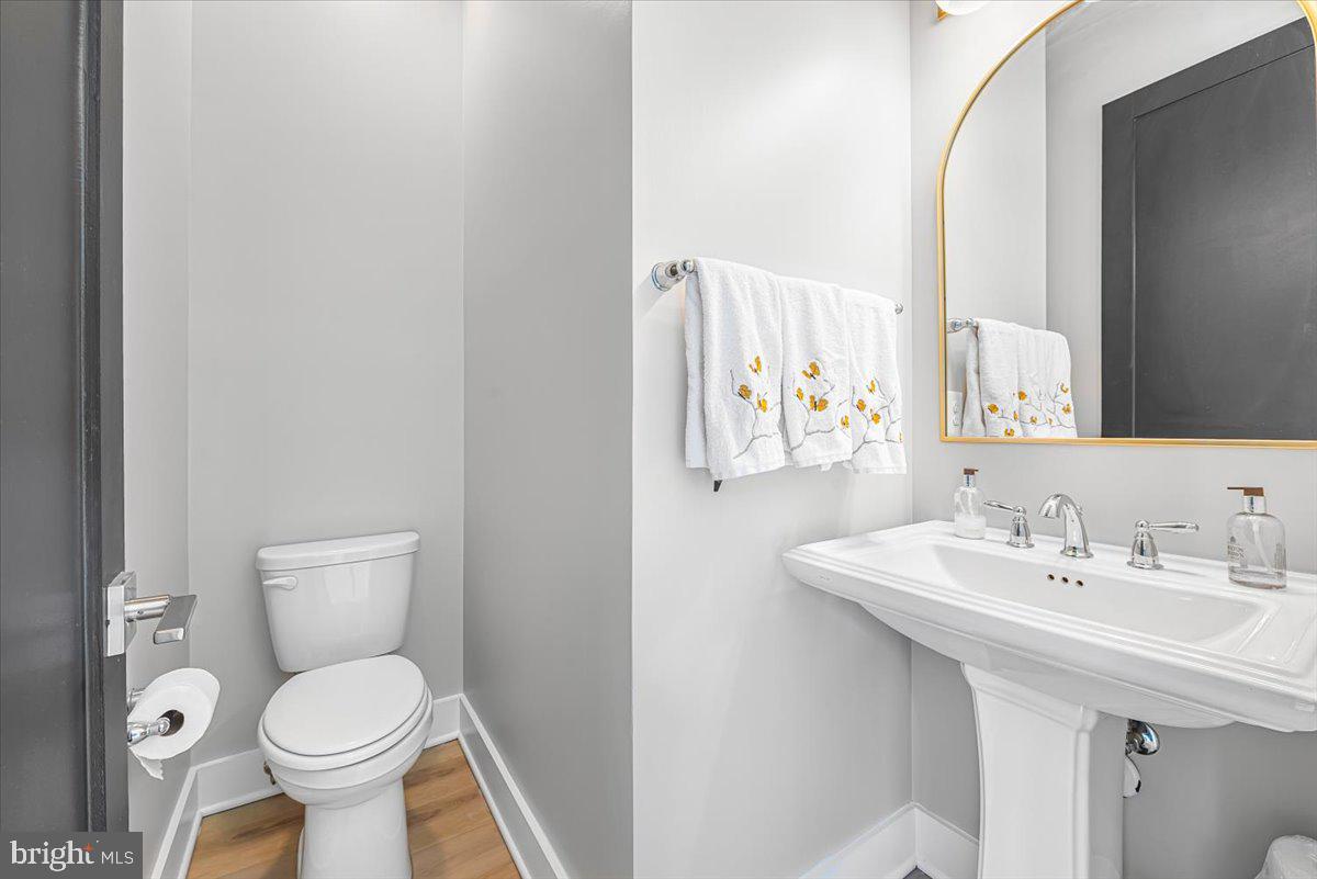 8197 River Road Bethesda, MD 20817 - Photo 36 of 53 a bathroom with a toilet sink and mirror