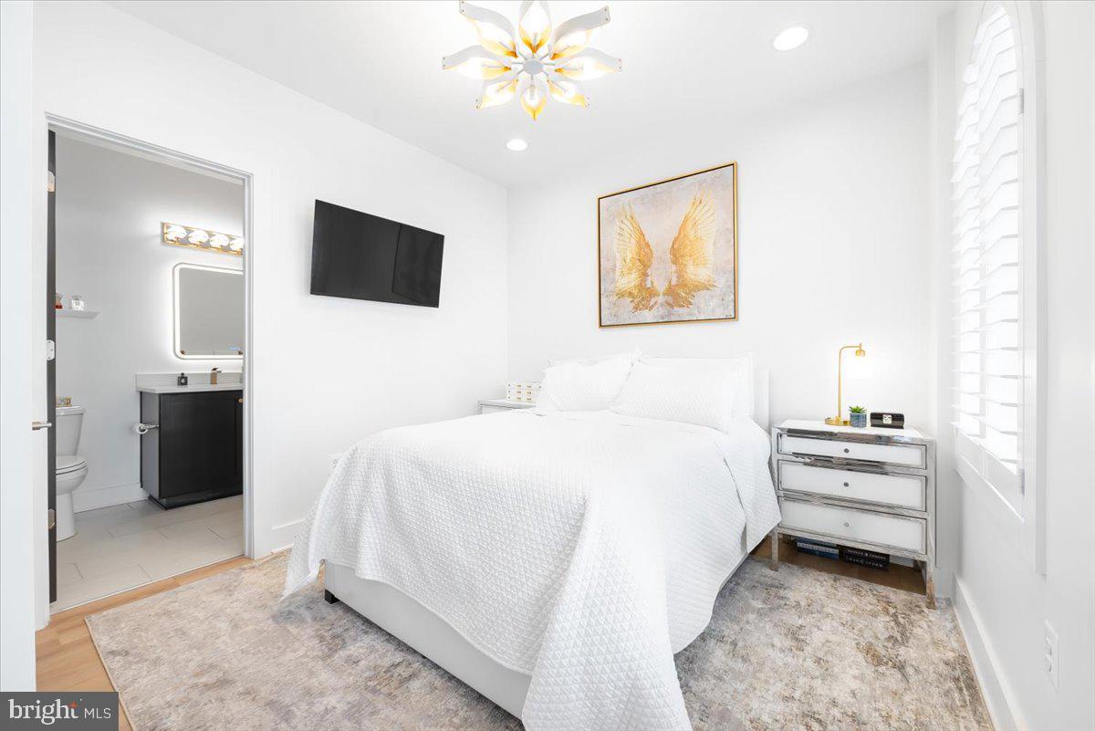 8197 River Road Bethesda, MD 20817 - Photo 7 of 53 a spacious bedroom with a bed and a ceiling fan