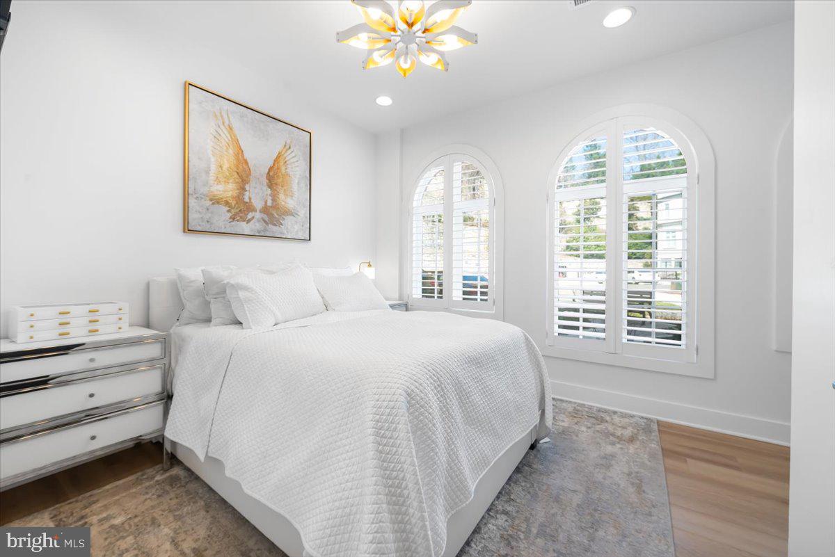 8197 River Road Bethesda, MD 20817 - Photo 8 of 53 a spacious bedroom with a bed and a window