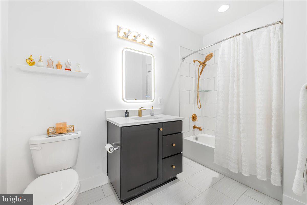 8197 River Road Bethesda, MD 20817 - Photo 9 of 53 a bathroom with a toilet sink and mirror