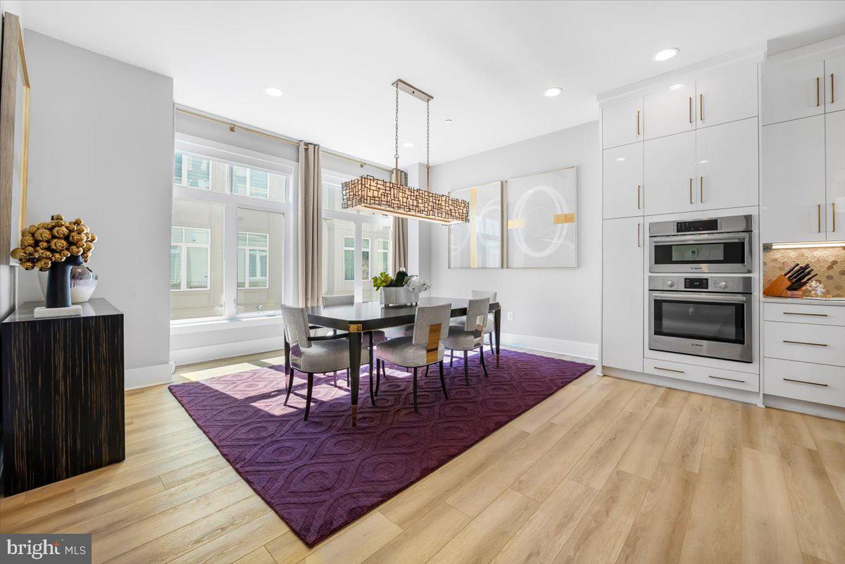 8197 River Road Bethesda, MD 20817 - Photo 10 of 53 a view of a dining room with furniture and wooden floor