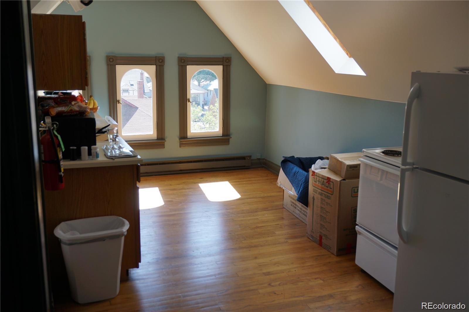 1444 Stuart Street Denver, CO 80204 - Photo 15 of 23 a living room with furniture window and wooden floor