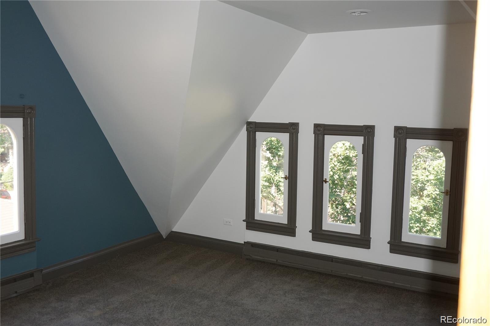 1444 Stuart Street Denver, CO 80204 - Photo 16 of 23 an empty room with windows