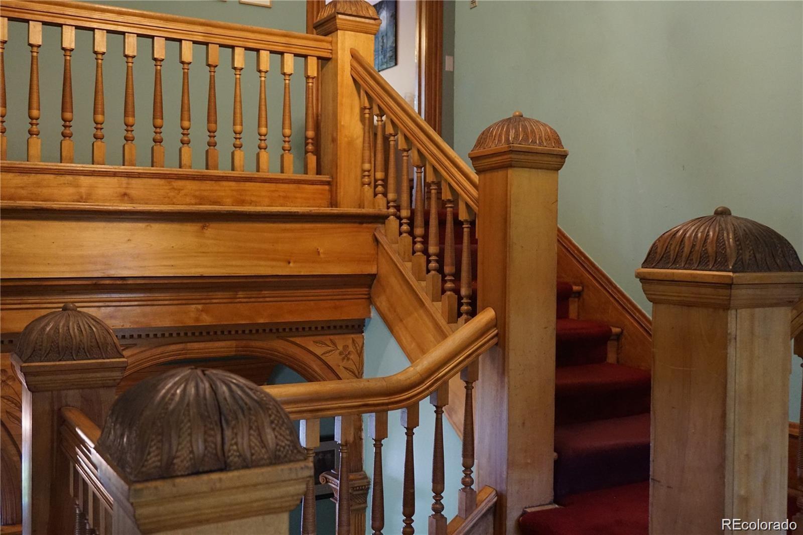 1444 Stuart Street Denver, CO 80204 - Photo 7 of 23 a view of staircase with railing and white walls