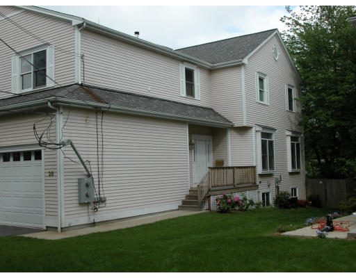 28 Tanglewood Road, Unit 28 Newton, MA 02459 - Photo 1 of 1 a view of a white house next to a yard