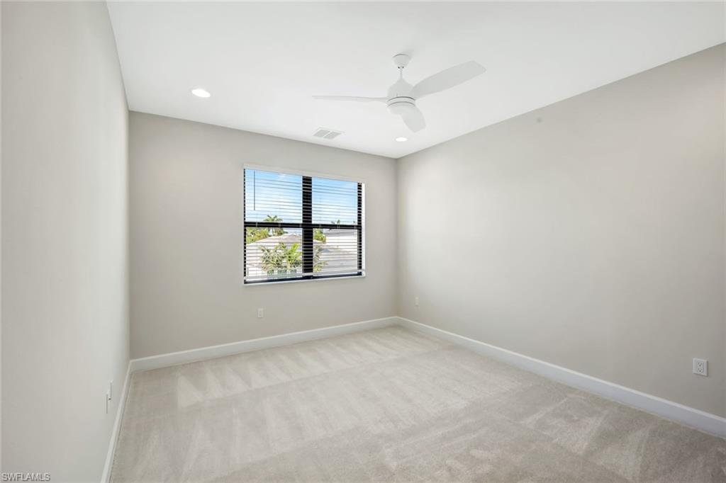 21023 Teak Tree Terrace Estero, FL 33928 - Photo 14 of 21 an empty room with a window and a ceiling fan