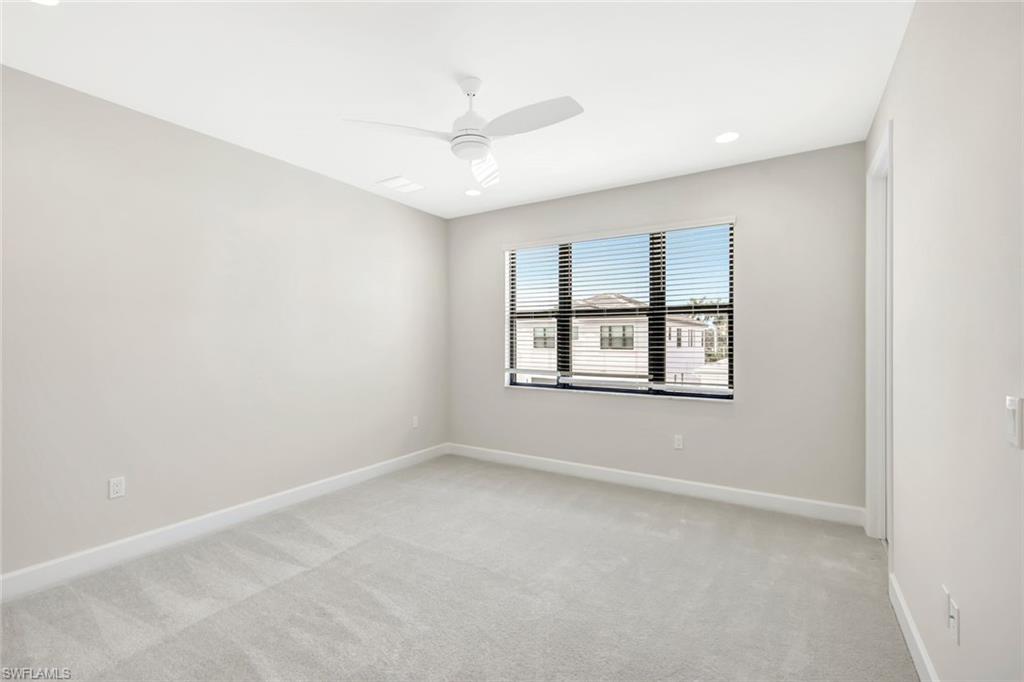 21023 Teak Tree Terrace Estero, FL 33928 - Photo 20 of 21 an empty room with windows and ceiling fan