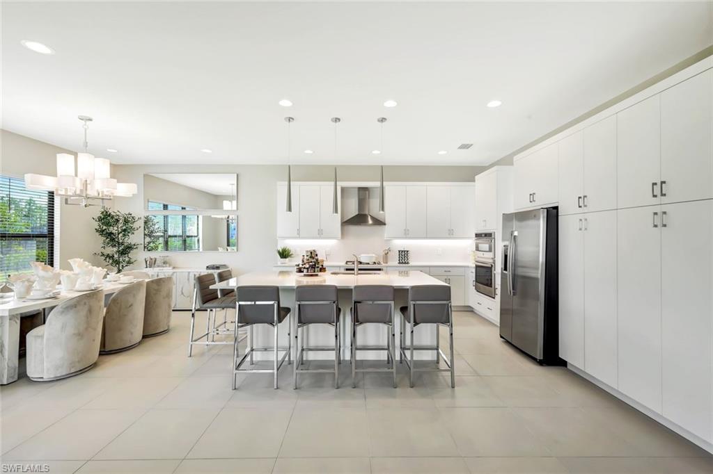 21023 Teak Tree Terrace Estero, FL 33928 - Photo 5 of 21 a large kitchen with a table and chairs