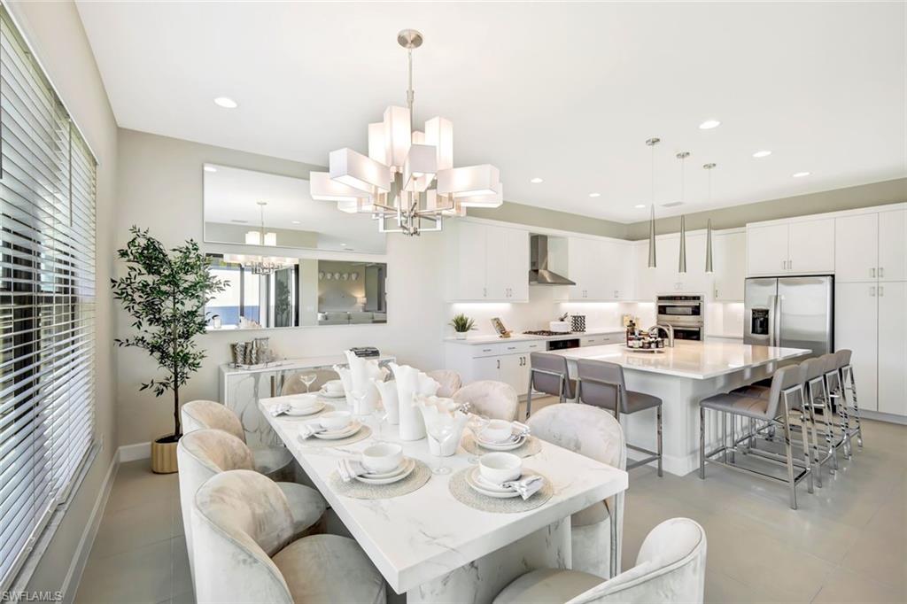 21023 Teak Tree Terrace Estero, FL 33928 - Photo 6 of 21 a view of a dining room with furniture and a chandelier