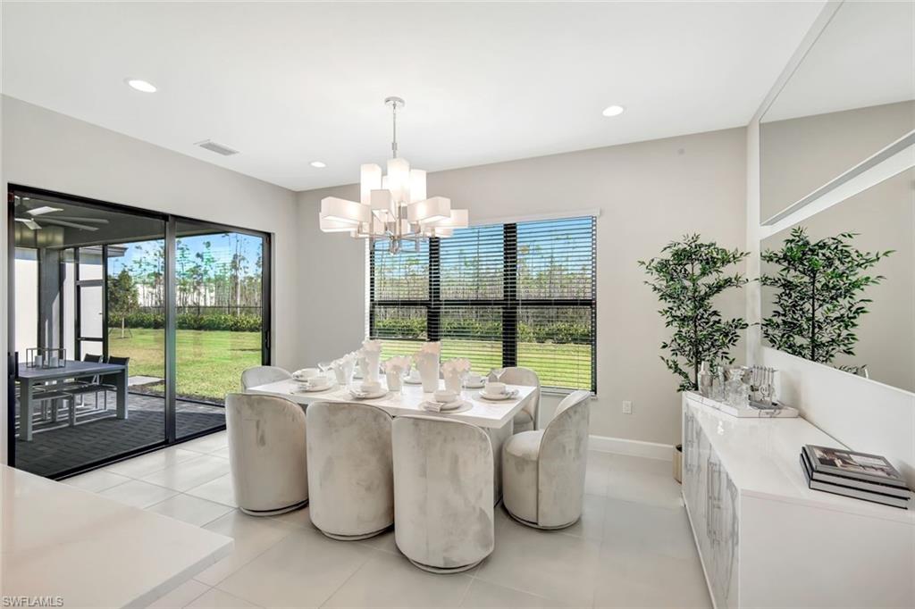 21023 Teak Tree Terrace Estero, FL 33928 - Photo 7 of 21 a dining room with furniture a chandelier and wooden floor