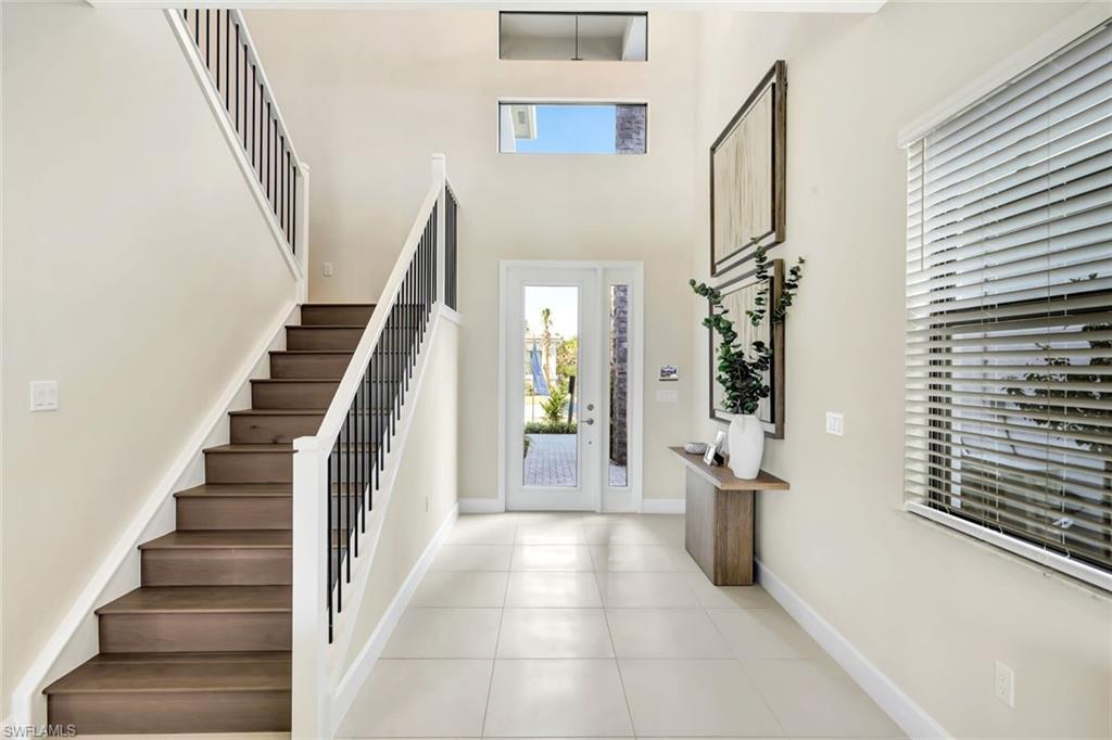 21023 Teak Tree Terrace Estero, FL 33928 - Photo 8 of 21 a view of a hallway with wooden floor and staircase