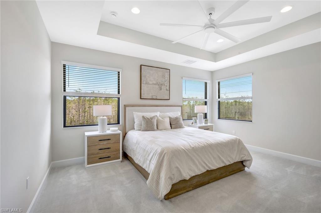 21023 Teak Tree Terrace Estero, FL 33928 - Photo 9 of 21 a bedroom with a bed chandelier and a window