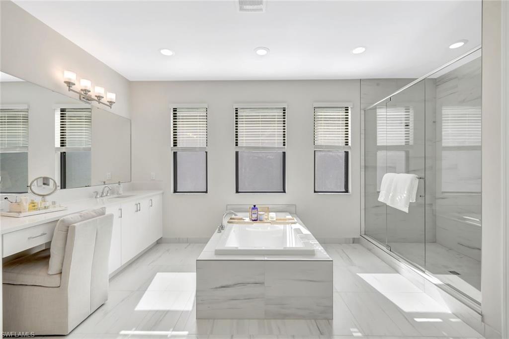 21023 Teak Tree Terrace Estero, FL 33928 - Photo 10 of 21 a spacious bathroom with a tub sink shower and mirror