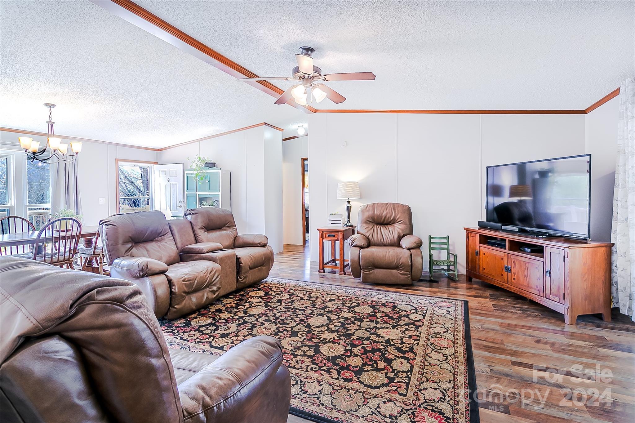 687 Newfound Road Leicester, NC 28748 - Photo 11 of 43 a living room with furniture and a flat screen tv