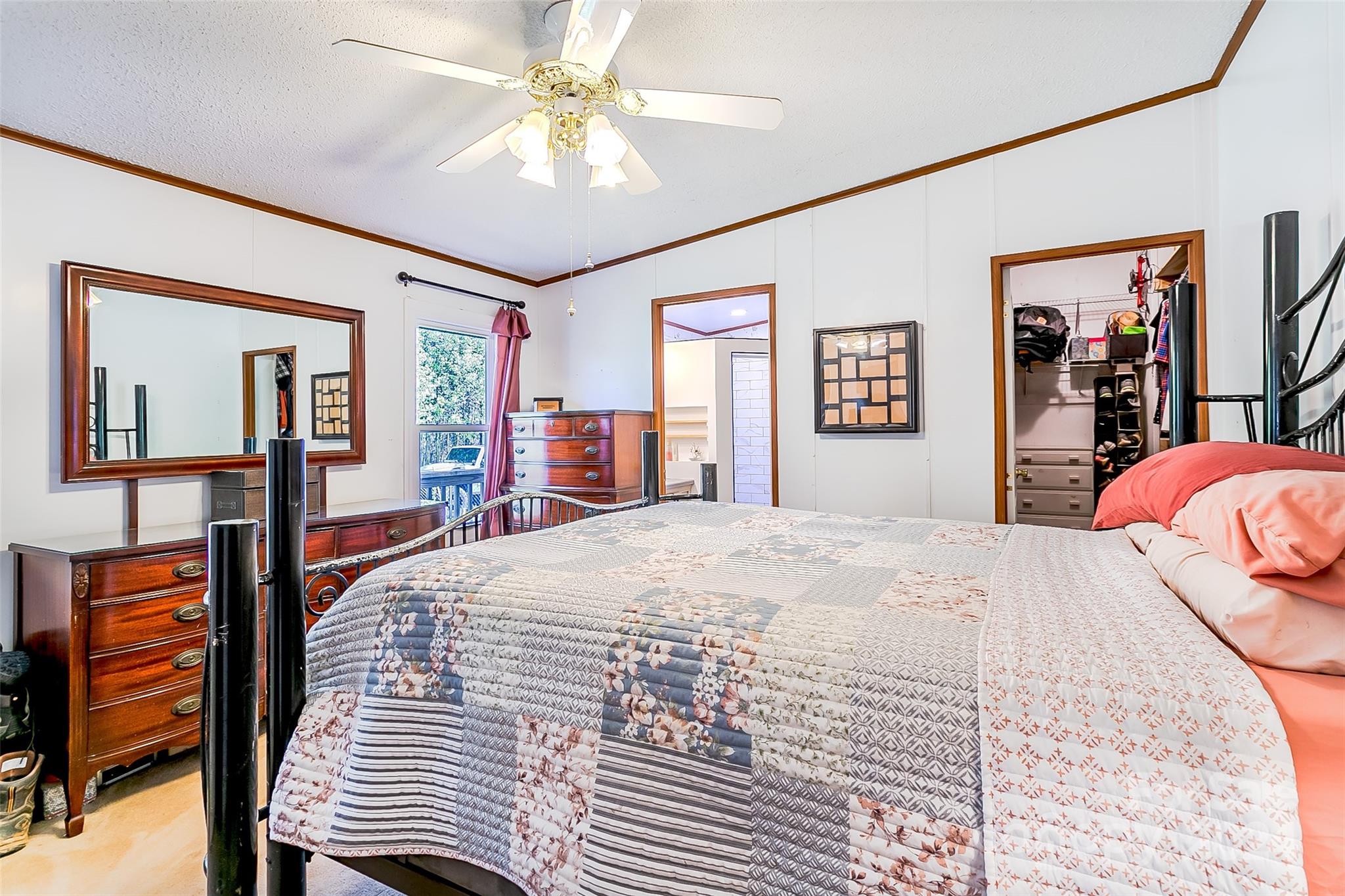 687 Newfound Road Leicester, NC 28748 - Photo 12 of 43 a bedroom with a bed and dresser with mirror