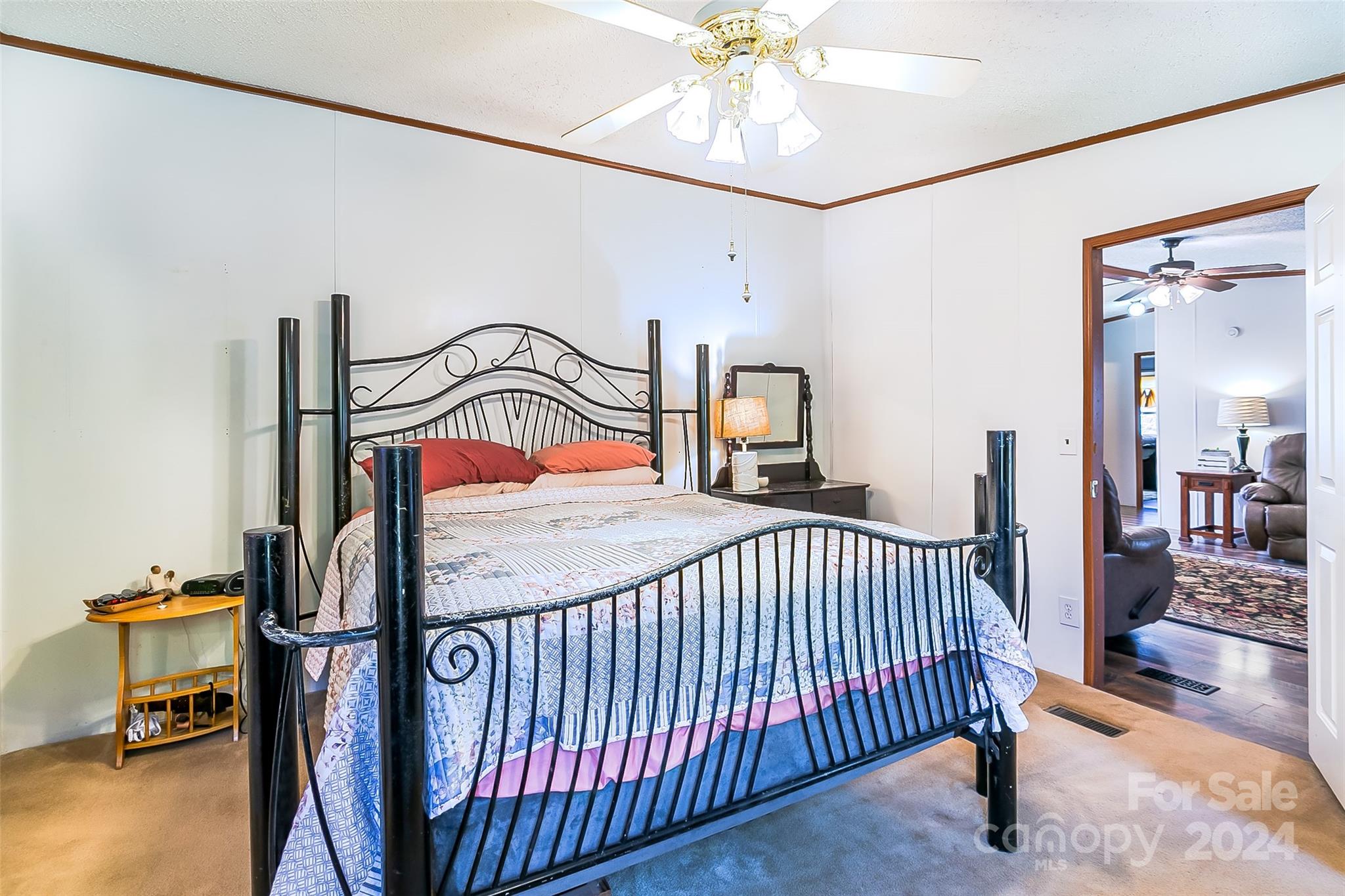 687 Newfound Road Leicester, NC 28748 - Photo 13 of 43 a bedroom with a bed and a chandelier