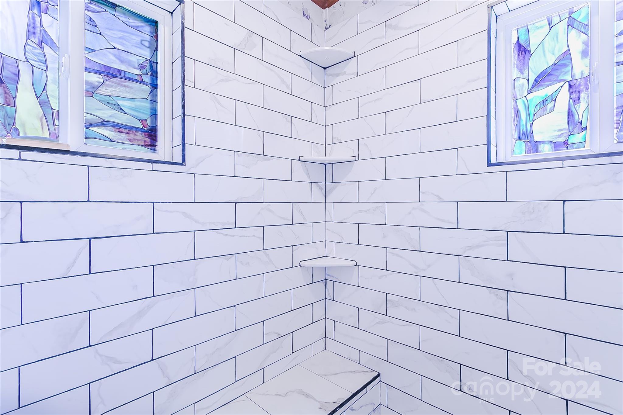 687 Newfound Road Leicester, NC 28748 - Photo 17 of 43 a bathroom with a sink and window