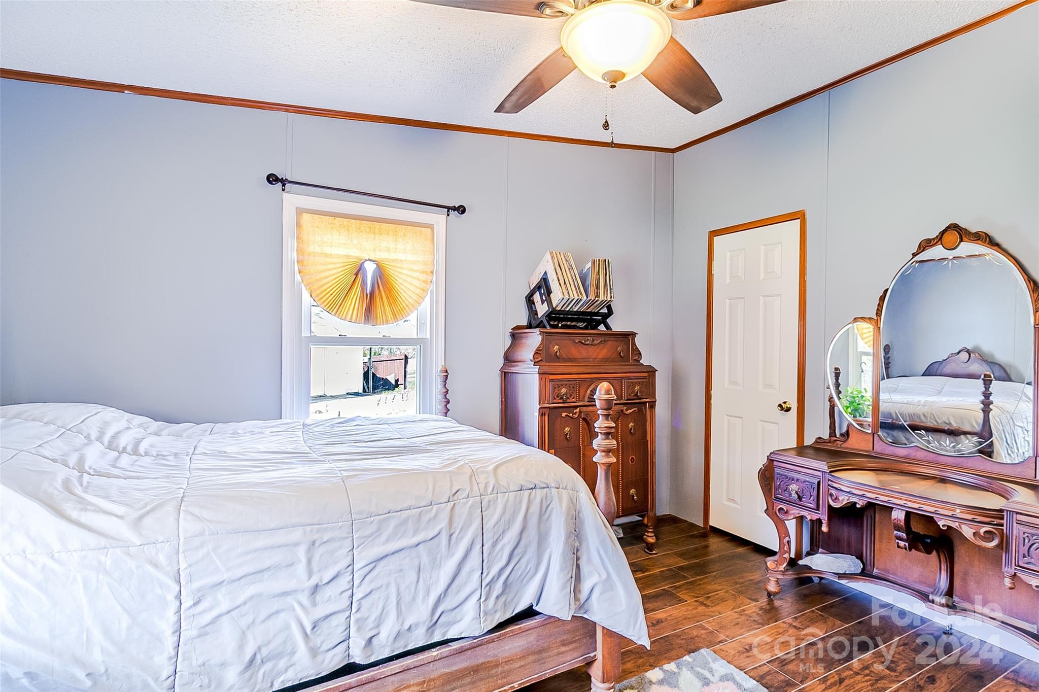 687 Newfound Road Leicester, NC 28748 - Photo 19 of 43 a bedroom with a bed and dresser with mirror