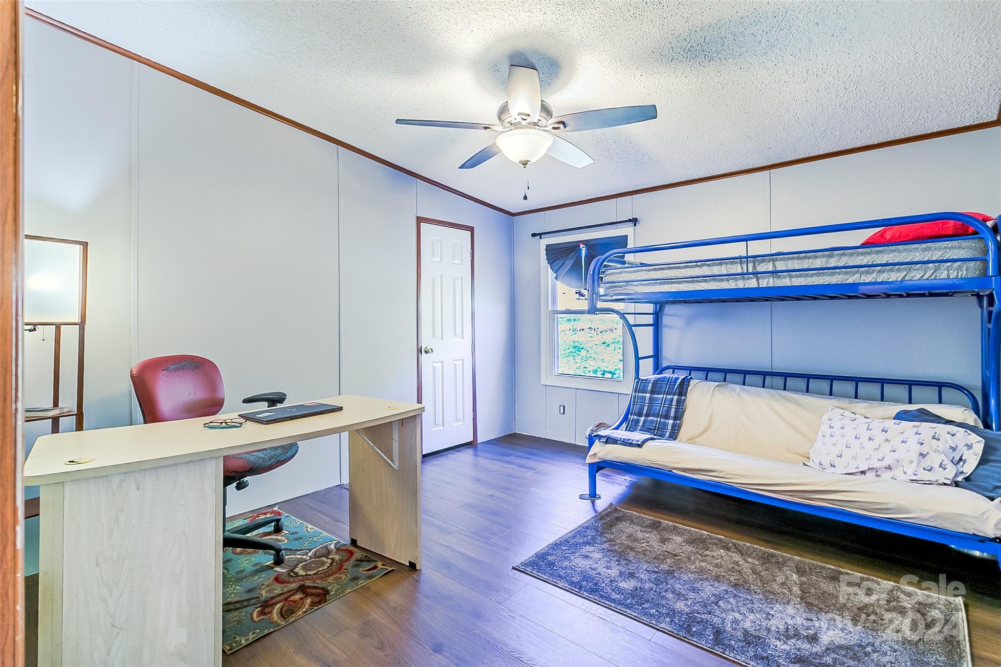 687 Newfound Road Leicester, NC 28748 - Photo 20 of 43 a bedroom with a bed and a chandelier