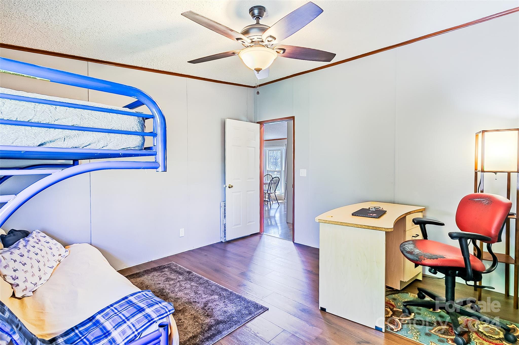 687 Newfound Road Leicester, NC 28748 - Photo 21 of 43 a bedroom with a bed and a chair with the wooden floor