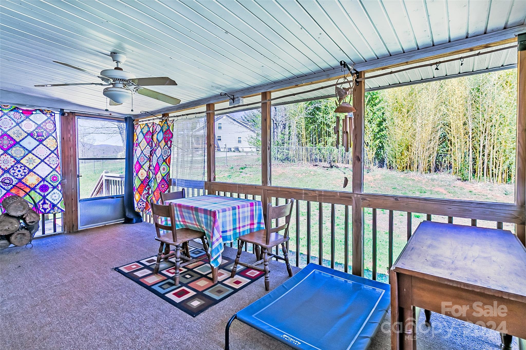 687 Newfound Road Leicester, NC 28748 - Photo 25 of 43 a living room with furniture a rug and a large window