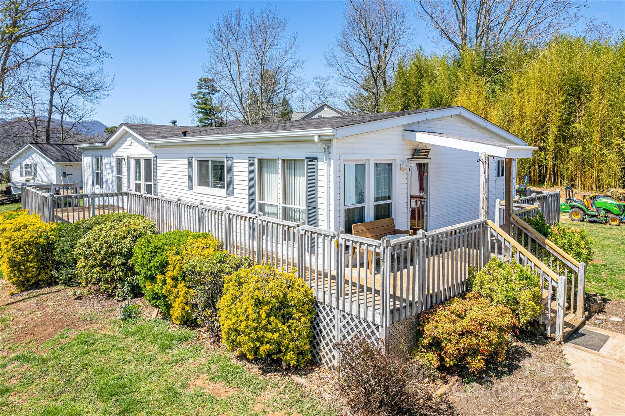 687 Newfound Road Leicester, NC 28748 - Photo 3 of 43 a view of a house with a small yard and wooden fence
