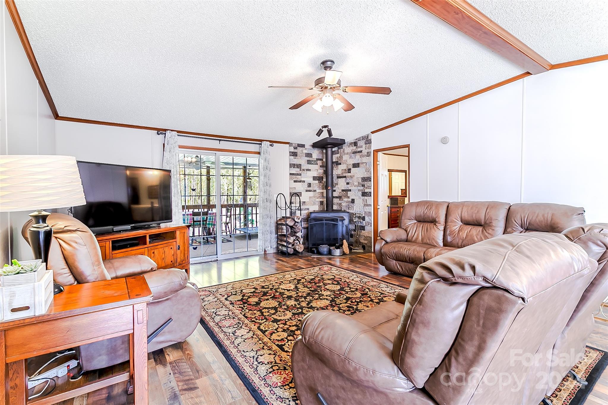 687 Newfound Road Leicester, NC 28748 - Photo 9 of 43 a living room with furniture a flat screen tv and a large window