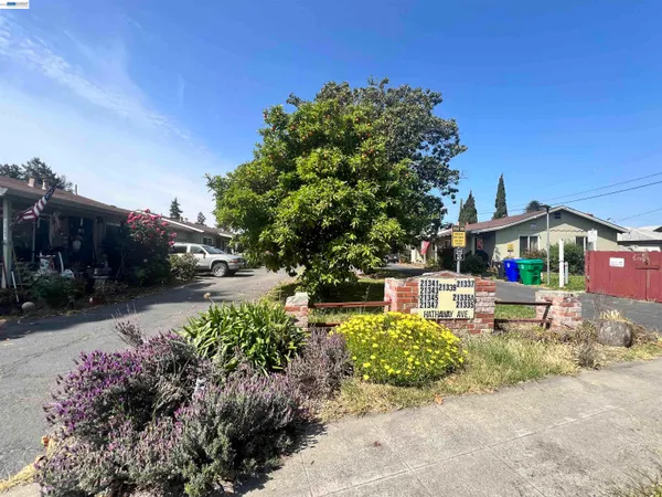 a front view of a house with a yard and a garden