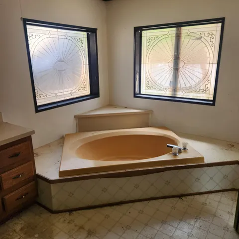 a bath tub sitting next to a window