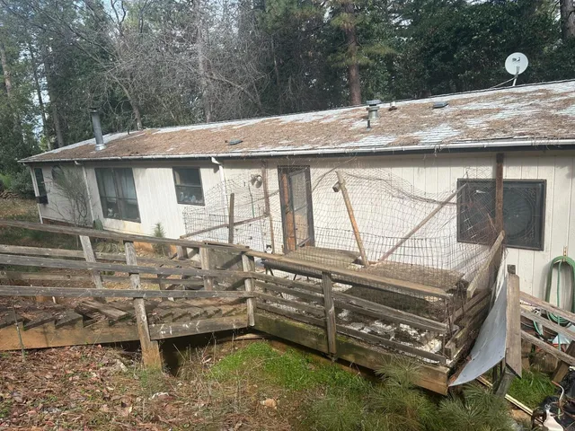 a view of a house with a bed and chairs