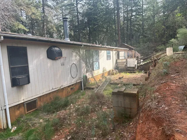 a yellow house with trees in front of it