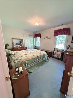 a bedroom with bed and window