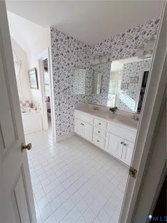 a bathroom with a granite countertop sink a toilet and a shower