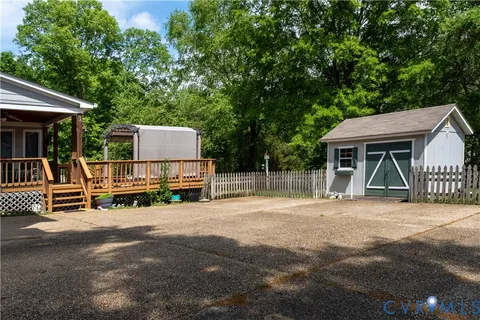 a view of a house with backyard porch and sitting area