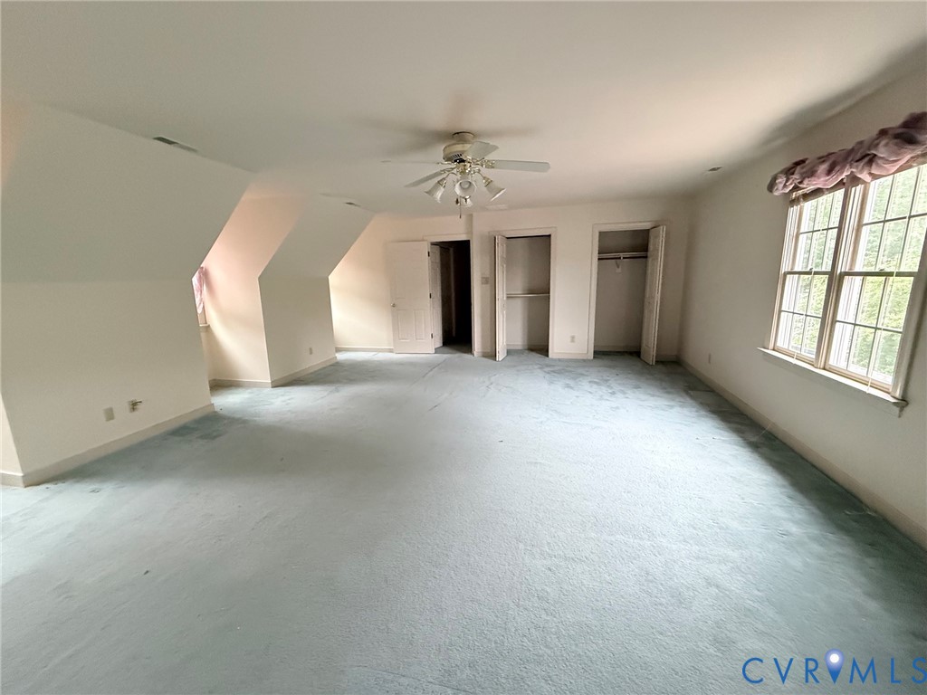 2301 Chartstone Drive Midlothian, VA 23113 - Photo 9 of 18 an empty room with windows and ceiling fan