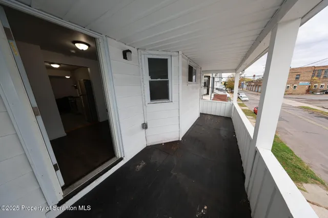 a view of a balcony and yard