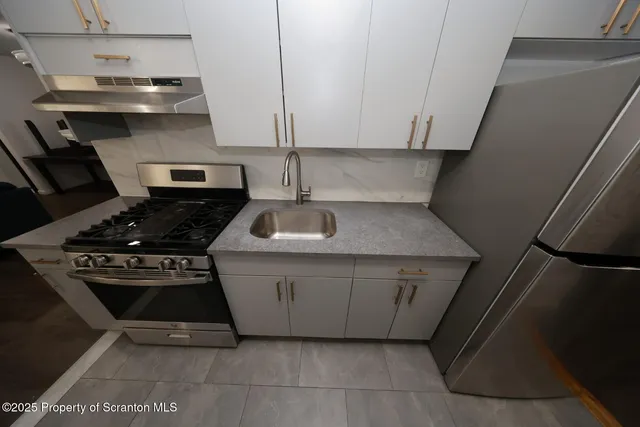 a kitchen with a stove and a sink